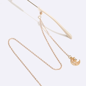 Golden eyeglass chain featuring moon pendant with white pearls and sparkling zircons