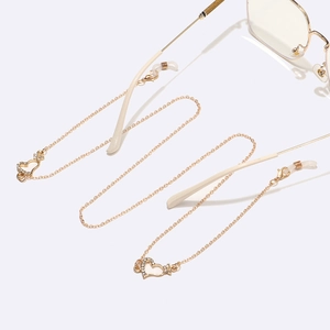 Golden eyewear chain with rhinestone heart pendants and adjustable silicone loops