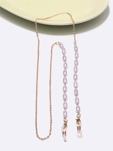 Gold chain glasses holder necklace featuring elegant white rice pearls on a white background