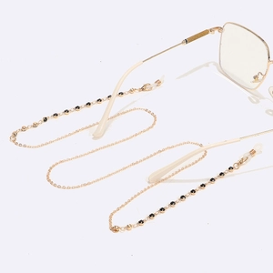 Chic gold eyewear chain with black rhinestones and silicone loops on gold glasses