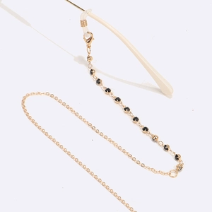 Fashionable gold eyewear chain with black rhinestones and non-slip silicone loops