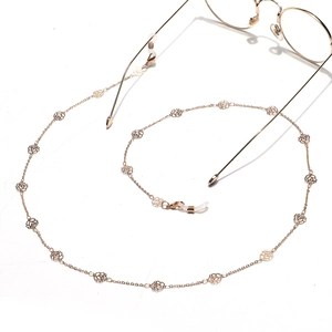Elegant gold glasses chain with hollow rose charms and adjustable silicone hooks on white