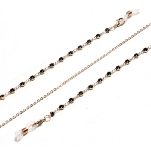 Golden eyewear chain with black rhinestones and silicone loops on a white background