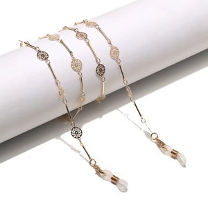 Golden eyewear chain featuring hollow circular floral links and adjustable rubber loops