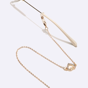 Gold glasses chain featuring rhinestone heart pendant and non-slip silicone loops