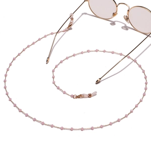 Detail of pink crystal beaded eyeglass chain with gold metal links and anti-slip loops
