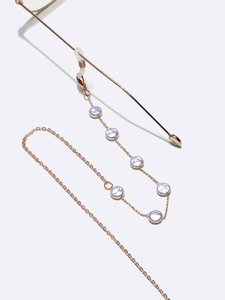 Golden metal eyewear chain with white pearls and silicone loops for sunglasses