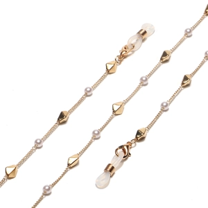 Elegant gold glasses chain with white pearls and geometric beads on a white background
