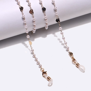 Detail of pearl eyewear chain featuring gold heart sequins and secure silicone loops