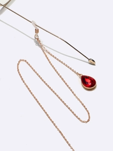 Golden metal eyewear chain featuring elegant red teardrop gemstone pendants for glasses