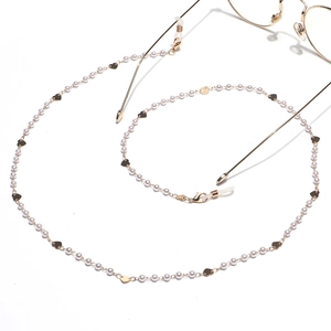 Golden heart charms and white pearl eyewear chain with secure silicone loops