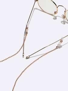 Two-piece golden beaded glasses chain with silicone loops shown on eyeglasses