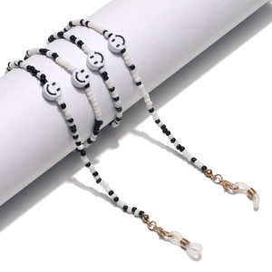 Fashionable black and white beaded glasses chain featuring smiley faces and golden clasps