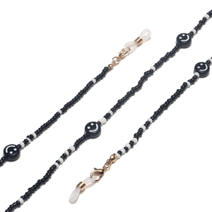Detail of beaded glasses chain with black and white seed beads and smiley face motifs