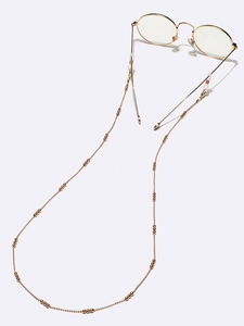 Golden beaded metal eyewear chain with non-slip rubber loops on round glasses
