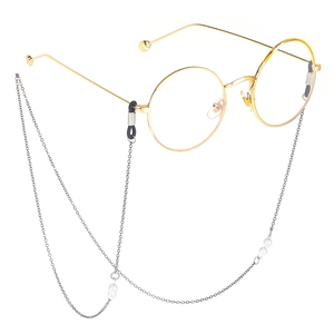 Elegant gold round glasses with a silver metal pearl chain on a clean white background