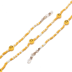 Close-up of yellow and white beaded eyewear chain featuring classic black smile face accents