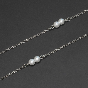 Detail of silver pearl chain featuring dual white pearls on a minimalist link cord