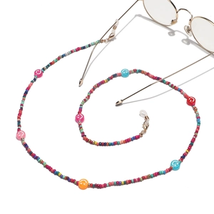 Detail of colorful seed bead eyewear chain with smiley faces and gold lobster clasp