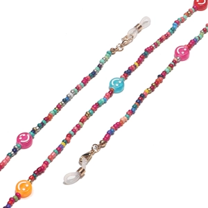 Close-up of colorful beads and smiley faces with gold lobster claws and silicone loops