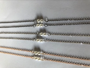 Detailed comparison of three metal finish eyewear chains with double white pearls
