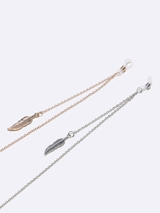 Close-up of gold and silver eyeglass chains with feather pendants and silicone ends
