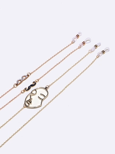 Golden eyewear chain set featuring glasses, mustache, and face silhouette charms