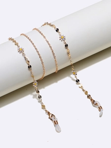 Golden handmade glasses chain with white daisy pendants and black disc accents