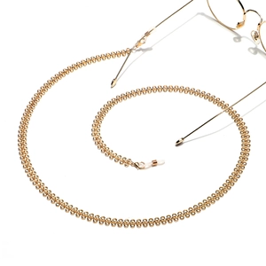 Minimalist golden copper eyewear chain with non-slip silicone loops on white background