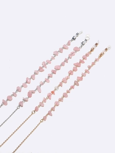Pink crystal and metal eyeglasses chain set in gold and silver finish on white background