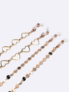 Golden eyewear chain set featuring heart and disc charms with silicone loops