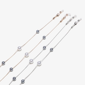 Set of two gold and silver pearl eyeglass chains with silicone loops on white backdrop