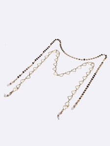 Golden eyewear chain set featuring hollow heart links and round disks with silicone loops