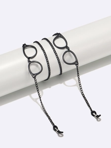 Detail of black metal eyewear chain featuring miniature glasses pendants and rubber loops