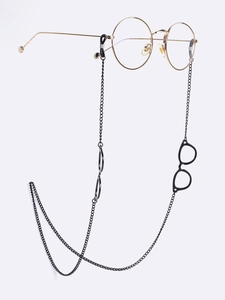 Close-up of black metal eyeglass chain with decorative eyeglass pendants on a golden frame
