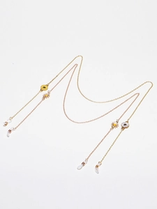 Golden daisy eyewear chain with yellow enamel flowers and adjustable silicone loops