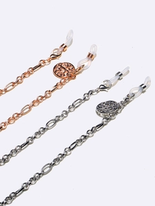 Detail of tree of life pendants on rose gold and silver eyeglass chains with silicone loops