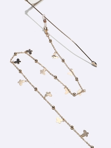 Golden eyewear chain with metal butterfly charms and beads on white background