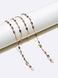 Detailed close-up of golden leaf glasses chain with adjustable silicone loops