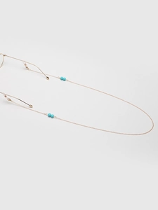 Detailed close-up of golden copper eyewear chain with turquoise beads and silicone loops