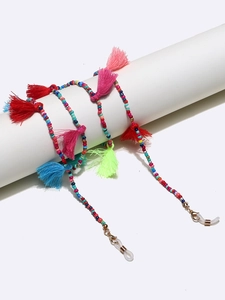 Detail of colorful beads and tassels on a handcrafted eyewear chain with silicone loops