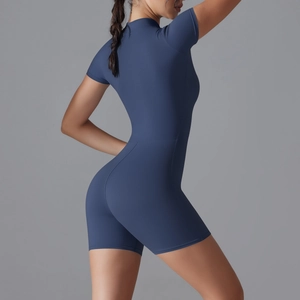 Close-up of the form-fitting back design and stretchy fabric of a navy blue yoga bodysuit