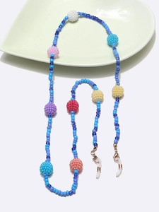 Detail of colorful beaded eyewear chain with multicolored pearls and golden lobster clasp