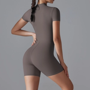 Rear view of sleek taupe short sleeve yoga romper showing fit and premium fabric