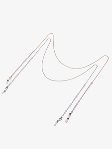 Detail of gold and silver eyeglass chains with pearls, lobster clasps and rubber loops