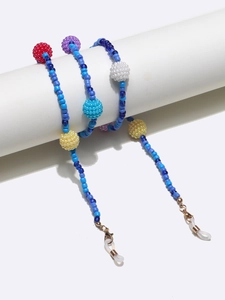 Detail of colorful beaded eyewear chain featuring large textured beads and lobster clasps