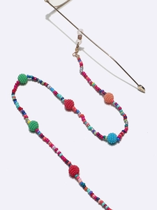 Detail of colorful beads and textured spheres on the handmade eyewear chain strap