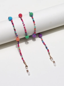 Detail of colorful beaded eyewear chain with rose gold lobster clasps and rubber loops