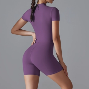 Detail of deep purple slim fit yoga romper featuring a short sleeve zipper design