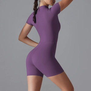 Detail view of the sleek back stitching and fit on a purple short-sleeve yoga bodysuit